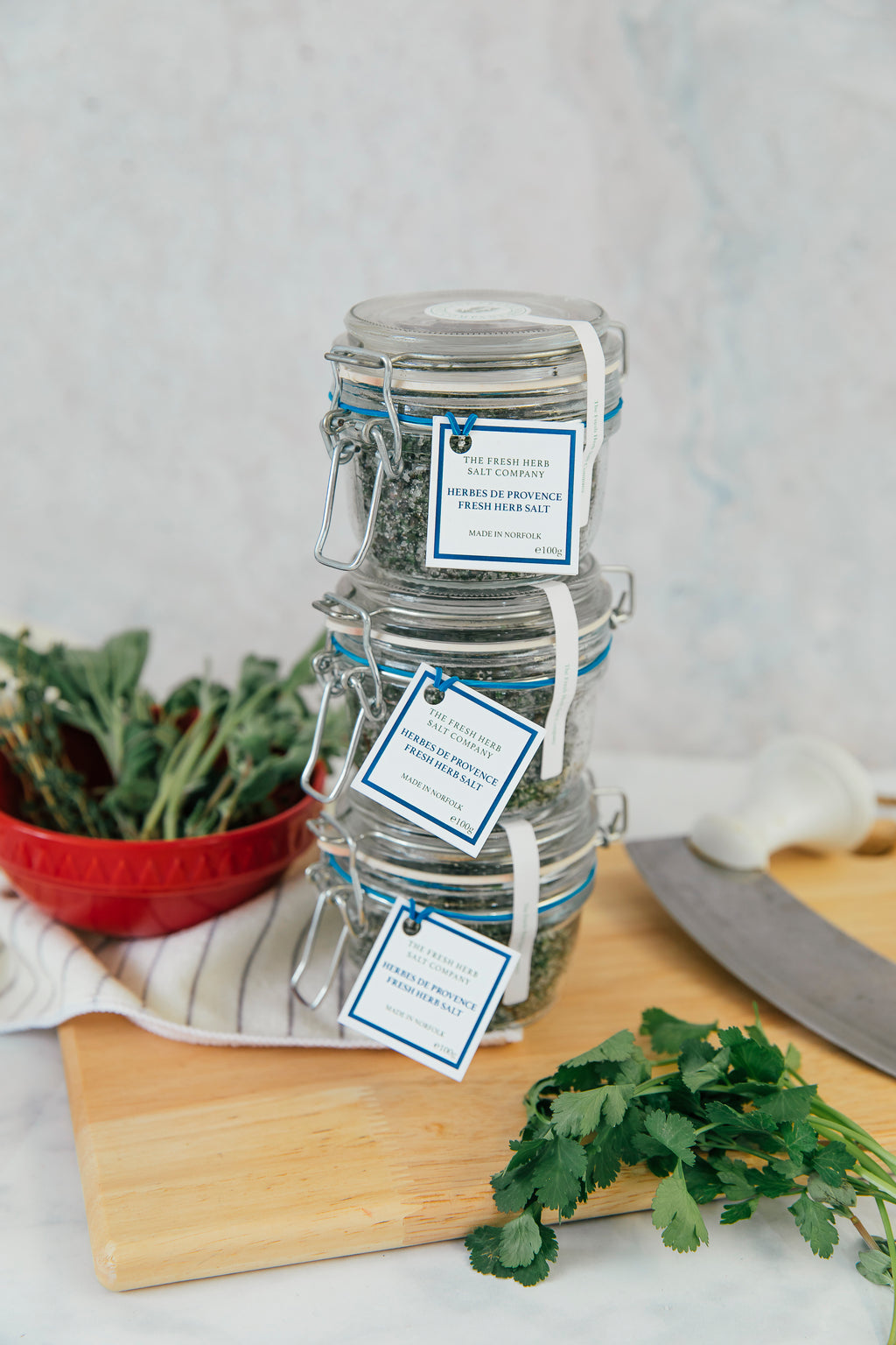 "Capture the essence of an French kitchen with this image showcasing 3 glass Kilner jars as a discounted package, filled with a blend of Herbes de Provence Fresh Herb Sea Salt Seasoning. The aromatic mix of marjoram, sage, parsley, and thyme intertwines with a combination of coarse and fine pure white sea salt for a visually stunning culinary experience.". A convenient way to save money and give a jar to your friends as a gift!"
