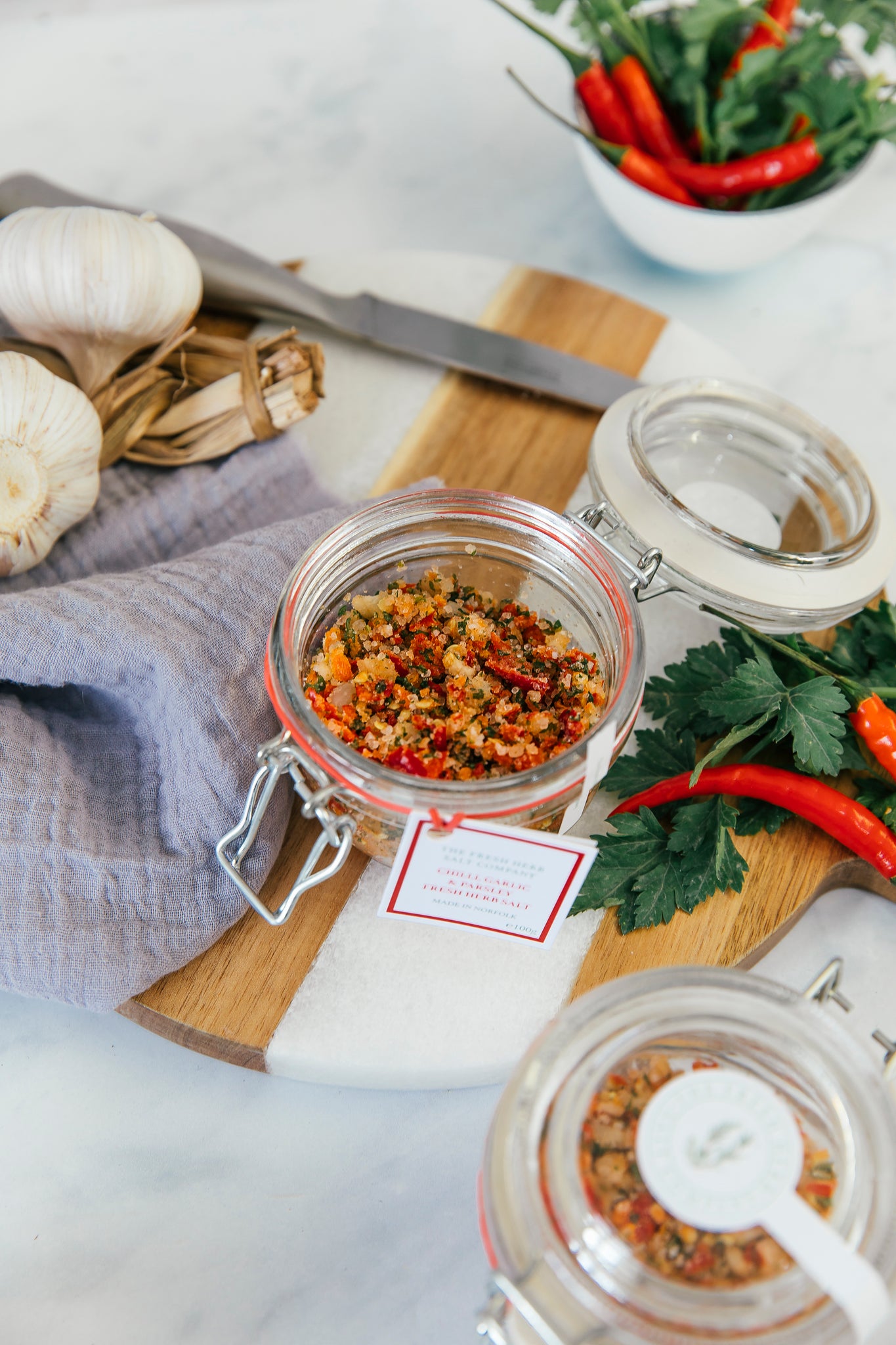Savour the essence of Chilli, Garlic, and Parsley Fresh Herb Seasoning melded with pure white coarse and fine sea salt in this picturesque glass Kilner jar. Designed for sustainability, the jar invites refilling with our practical and eco-friendly refill pouches