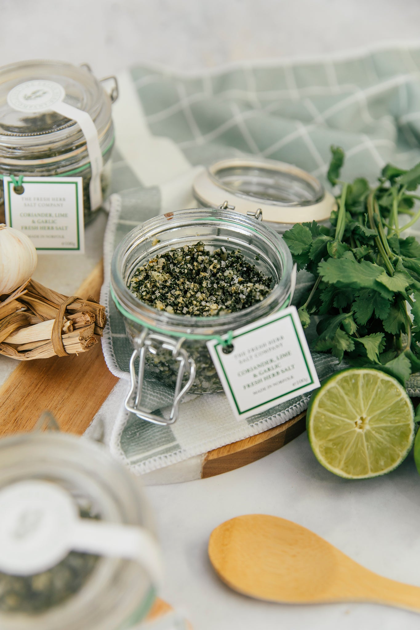 Experience the aromatic appeal of Coriander, Garlic, and Lime Fresh Herb Seasoning seamlessly mixed into pure white coarse and fine sea salt, elegantly stored in a glass Kilner jar. The jar's reusability is emphasized, providing an eco-friendly option for replenishment with our refill pouches