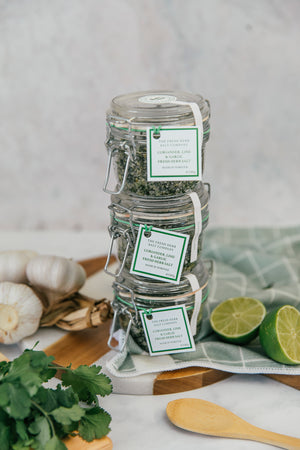 Experience the aromatic appeal of Coriander, Garlic, and Lime Fresh Herb Seasoning seamlessly mixed into pure white coarse and fine sea salt, elegantly stored in a glass Kilner jar. The jar's reusability is emphasized, providing an eco-friendly option for replenishment with our refill pouches.  There is a discounted price for this offer of 3 jars - and you can give one as a gift to your friends.