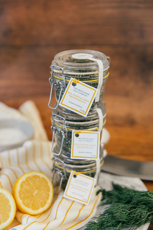 Delight your senses with this visually appealing scene featuring 3 glass Kilner jars filled with the vibrant flavors of Dill, Garlic, and Lemon Fresh Herb Seasoning blended into pure white coarse and fine sea salt. The jar's reusable design invites eco-conscious customers to refill with our practical pouches.  These come at a discounted price enabling you to gift a jar to your friends too!
